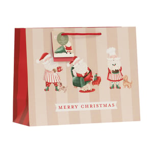 Make gift-giving extra special this Christmas with our delightful Medium Shopper Santa Gift Bag. This charming bag boasts a whimsical design featuring three different Santas enjoying festive activities – from baking and relaxing to sharing cookies with their adorable dog companions. The classic striped background, vibrant red sides, and sturdy red rope handles add a touch of quality and festive cheer. Each bag includes an eco-friendly tag, highlighting its recycled credentials, perfect for the environmentally conscious shopper. With "Merry Christmas" proudly displayed, this bag is ideal for presenting gifts to loved ones. Available in a convenient pack of 6, these bags from Partisan Products Ltd are a wonderful addition to your holiday offerings.