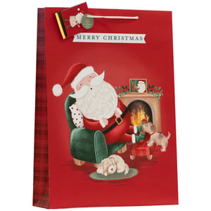 Bring festive cheer to your customers' gifts with our Jumbo Sleepy Santa Gift Bag. This delightful bag features a heartwarming illustration of Santa Claus relaxing by a crackling fireplace in a cosy plaid armchair, surrounded by his adorable canine companions. One sleepy pup dozes on a rug, while another gazes up at Santa, creating a truly charming scene.
The vibrant red design is complemented by a classic 'MERRY CHRISTMAS' banner and a coordinating plaid side panel. Each bag comes with a sweet Santa-themed gift tag, complete with a 'Biofriendly' stamp, adding an extra touch of thoughtfulness. Perfect for larger presents, this sturdy bag ensures your customers' gifts are beautifully presented. Available in a convenient pack of 6. Supplier: Partisan Products Ltd.