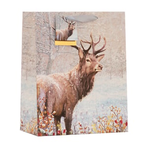 Present your gifts with a touch of winter elegance using our Medium Winter Stag Gift Bag from Partisan Products Ltd. This beautiful bag showcases a majestic stag standing proudly in a serene, snow-dusted forest, captured in a charming painterly style. Gentle snowflakes drift around the impressive creature, while subtle hints of warm red and yellow foliage add a natural pop of colour to the wintry scene.
Ideal for Christmas, winter birthdays, or any special occasion, its sophisticated design and sturdy construction make it a perfect choice for a variety of gifts. Each bag features a coordinating ribbon handle for a refined finish. Available in a convenient pack of 6, these gift bags are sure to be a popular choice for your customers, adding festive charm to their presents.