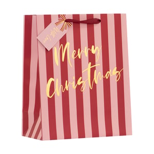 Make your festive gifts truly shine with our delightful Medium Pink Stripe Gift Bag. This charming bag features a stylish design of alternating pink and red stripes, creating a modern yet classic Christmas look.
Adding a touch of elegance, the front is adorned with beautiful gold foil 'Merry Christmas' lettering. Each bag comes complete with a coordinating pink gift tag, featuring a sweet 'With Love' message and a delicate gold bow design, making your presents ready to go.
Finished with sturdy red ribbon handles, this medium-sized bag is perfect for a variety of gifts. Stock up for the season with our convenient pack of 6, ensuring you have plenty of stylish options for your customers.