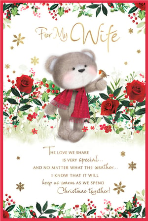 Make her Christmas truly special with this adorable 'For My Wife' Christmas card from Simon Elvin. This charming card features a sweet teddy bear, wrapped in a festive red scarf, gently holding a little robin. The delightful scene is framed by beautiful holly, berries, and classic red roses, with sparkling gold snowflakes adding a touch of magic.

Inside, a heartfelt message reads: "The love we share is very special... and no matter what the weather... I know that it will keep us warm as we spend Christmas together!" This thoughtful sentiment is sure to warm her heart. Perfect for retailers, these lovely cards come in a convenient pack of 6.