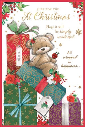 Spread festive cheer with this adorable Christmas card, perfect for sending warm wishes to a special female recipient. Featuring a charming teddy bear nestled amongst a delightful pile of beautifully wrapped presents, this design captures the magic of the season. Rich reds, greens, and golds are accented with festive holly, berries, and poinsettias, creating a truly heartwarming scene.

The sweet message inside reads: "JUST FOR YOU At Christmas Hope it will be simply wonderful- All wrapped in happiness..." A truly lovely way to share joy this holiday season. Supplied by Simon Elvin, these cards come in a convenient pack of six, ensuring you're ready to spread happiness.