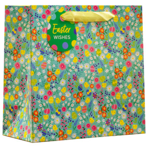 Get ready for a delightful Easter with our Large Easter Ditsy Gift Bag! Perfect for presenting those special seasonal treats, this charming bag features an adorable ditsy pattern of cheerful yellow chicks, colourful Easter eggs, and a vibrant medley of spring flowers on a fresh teal background. The design is wonderfully whimsical and sure to bring a smile to any recipient's face.
Each bag comes complete with sturdy yellow ribbon handles and a sweet egg-shaped 'Easter Wishes' gift tag, adding that extra touch of thoughtfulness. Ideal for a wide range of Easter gifts, from chocolates to toys, these bags offer both beauty and practicality. Available in a convenient pack size of 1x6 from Partisan Products Ltd, they're a must-have addition to your seasonal stock. Brighten up your customers' Easter gifting with these lovely bags!