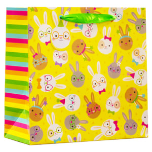 Add a touch of Easter cheer to your gift-giving with our delightful Medium Easter Bunnies Gift Bag! This charming bag features an array of adorable cartoon bunnies, each with their own unique accessories, set against a vibrant yellow background. The colourful striped side panels and bright green ribbon handle complete the playful design, making it perfect for presenting treats and gifts. Sure to bring a smile, these eye-catching bags are an essential for the spring season. Supplied by Partisan Products Ltd., they come in a convenient pack of 6, ready to brighten up your retail display.