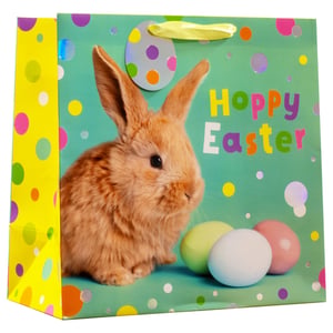 Get ready for Easter with our delightful Large Hoppy Easter Gift Bag! This charming bag features an adorable fluffy bunny, vibrant pastel eggs, and a cheerful "Hoppy Easter" message in colourful lettering. The bright green background, adorned with playful polka dots, and a sunny yellow side panel make it truly eye-catching.
Perfect for presenting Easter treats, toys, or gifts, this bag is sure to bring a smile to anyone's face. Its generous size makes it versatile for a variety of items. Stock up for the festive season with our convenient pack of 6, supplied by Partisan Products Ltd. Ensure your customers have the perfect way to share their Easter joy!