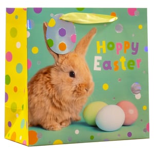 Bring a touch of springtime joy to your customers' Easter celebrations with our delightful Medium Hoppy Easter Gift Bag! This charming bag features an adorable fluffy bunny, vibrant "Hoppy Easter" text, and a playful scattering of colourful polka dots. Three pastel Easter eggs complete the festive scene, all set against a cheerful mint green background with a bright yellow side panel.
Shiny, holographic dots add an extra sparkle, making this bag truly eye-catching. Perfect for presenting Easter treats and gifts, these medium-sized bags are sure to be a hit. Available in a convenient pack of 6, they're ideal for retailers looking to stock up on popular seasonal essentials.
