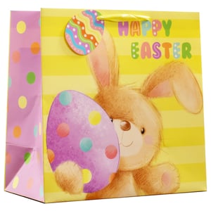 Bring a touch of Easter magic to your customers' celebrations with our delightful Large Cute Bunny Easter Gift Bag! This charming bag features an adorable brown bunny peeking playfully from behind a vibrant purple polka-dotted egg, all set against a cheerful yellow striped background. The "HAPPY EASTER" message in colourful, bubbly letters adds to the festive spirit.
With a bright pink polka-dotted side panel and a matching decorative egg tag, this large gift bag is perfect for presenting Easter treats and gifts. Designed to make any present extra special, these bags are sure to be a hit. Available in a convenient pack of 6, they're ideal for retailers looking to stock up on seasonal essentials.