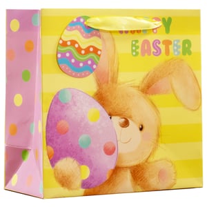 Make every Easter gift extra special with our Medium Cute Bunny Easter Gift Bag! This delightful bag features an adorable brown bunny peeking playfully from behind a vibrant purple polka-dotted Easter egg, guaranteed to bring smiles. The cheerful yellow striped background is adorned with a colourful 'Happy Easter' message and another charming patterned egg.
The side panels add an extra touch of fun with their bright pink and multi-coloured polka dot design. Perfect for presenting treats, toys, or small gifts, these bags are ideal for Easter egg hunts, family gatherings, or customer giveaways. Supplied by Partisan Products Ltd., each pack contains 6 of these charming gift bags, ready to add a touch of festive joy to your seasonal offerings.