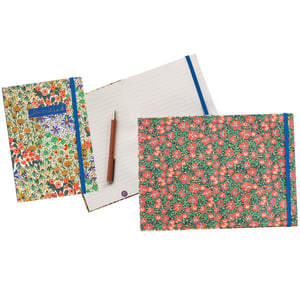 Discover the enchanting Liberty Garden A5 Notebook, a delightful addition to any stationery collection. From Partisan Products Ltd, these beautiful A5 notebooks are sold individually, allowing you to choose your favourite design.

Each notebook features a vibrant floral pattern, bringing a touch of nature to your notes. The image showcases two distinct styles: one with a rich, varied garden motif and a "Notebook" label, and another adorned with charming red flowers on a lush green background. Inside, you'll find neatly lined pages, perfect for jotting down thoughts, plans, or creative ideas. A practical blue elastic band keeps your pages secure, making it ideal for on-the-go use. Elevate your everyday writing with these beautiful and functional notebooks.