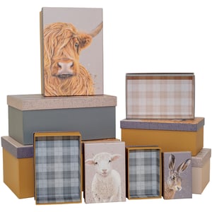 Introduce a touch of rustic charm to your customers' homes with our delightful Cedar & Sage 10 Nested Boxes. This versatile set, supplied by Partisan Products Ltd, offers a perfect blend of practicality and heartwarming design.

Each box is beautifully crafted, featuring a harmonious palette of earthy tones, including soft greys and warm mustards. The collection showcases charming illustrations of beloved countryside animals – a majestic Highland Cow, an adorable lamb, and a curious hare – bringing a unique character to each piece. Inside, you'll discover subtle plaid patterns that add an extra layer of country appeal.

Ideal for gifting, storage, or simply as decorative accents, these nested boxes are a must-have for any retail space looking to offer quality and style. Sold as a single pack, they're ready to enchant your customers.