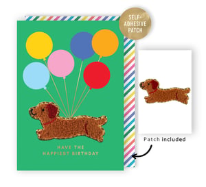 Send the happiest birthday wishes with this charming 'Open Birthday Female' card from Second Nature. This vibrant green card features a sweet, textured brown dog, reminiscent of a dachshund, playfully floating with a colourful bunch of balloons. The cheerful design is completed with a bright striped border.
A fantastic feature of this card is the included self-adhesive patch! The adorable dog can be easily removed and applied to clothing, bags, or other items, providing a lovely memento. With the warm message "HAVE THE HAPPIEST BIRTHDAY," it’s a wonderful choice for celebrating a special woman or girl. Available in a convenient pack of 6.