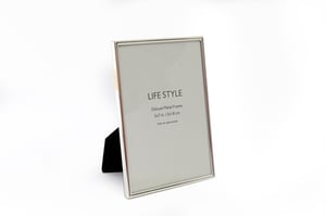 Elevate your cherished memories with our exquisite 5"x7" Silver Plated Edge Photo Frame. Crafted with a sleek, silver-plated finish, this frame adds a touch of timeless elegance to any room. Its classic design beautifully showcases your favourite 5x7 inch photographs, making it perfect for displaying on a mantelpiece, desk, or shelf. The sturdy construction ensures your precious moments are presented with sophistication. Each frame is sold individually, ready to bring a refined touch to your home or as a thoughtful gift. A truly stylish way to celebrate your life's special moments.