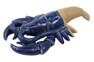 Introduce a touch of seaside elegance to your customers' homes with our stunning 27.5cm Lobster Deco. This eye-catching piece boasts a vibrant, glossy blue ceramic finish for the main body, beautifully contrasted with a textured, sandy-toned tail. Its unique two-tone design and intricate detailing make it a truly distinctive decorative item. Perfect for enhancing nautical themes, adding a pop of colour to any room, or as a charming garden accent. Supplied individually by Sifcon International PLC, this high-quality lobster decoration is sure to be a popular choice for those seeking unique and stylish home accessories.