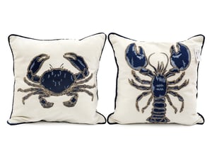 Introduce a delightful touch of coastal charm to any home with our 45cm Lobster/Crab Square Cushions. This charming duo features intricately detailed marine life, with one cushion showcasing a majestic navy blue lobster and the other a handsome crab. Each design is beautifully embroidered or appliqued onto a crisp, cream-coloured fabric, highlighted with subtle golden accents and finished with elegant dark piping.
Perfect for adding a nautical flair to living rooms, conservatories, or holiday lets, these square cushions offer both comfort and style. Sold as a convenient pack of two, they provide an instant, cohesive decorative update. Elevate your homeware collection with these unique and eye-catching pieces.