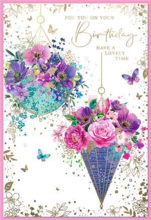 Celebrate her special day with this exquisite 'Open Birthday Female' card from Simon Elvin. This stunning design features two beautifully illustrated hanging floral arrangements, bursting with vibrant shades of pink, purple, and blue. Delicate gold accents, shimmering butterflies, and subtle splatters add an elegant touch, creating a truly artistic and celebratory feel. The heartfelt message, 'For You On Your Birthday, Have A Lovely Time,' is presented in elegant gold script, making it perfect for any female recipient. Stock up on these gorgeous cards, available in a convenient pack of 6, and ensure your customers have the perfect way to send their warmest birthday wishes.