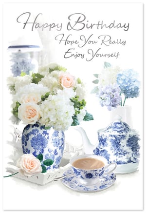 Celebrate her special day with this exquisite 'Open Birthday Female' card from Simon Elvin. This charming design features a delightful tea party scene, perfect for conveying warm wishes. Elegant white and peach roses, alongside soft blue and purple hydrangeas, are beautifully arranged in classic blue and white patterned vases. A matching teacup and teapot add to the serene and sophisticated ambiance. The heartfelt message, "Happy Birthday Hope You Really Enjoy Yourself," is presented in a graceful script font. Ideal for any female recipient, this card offers a touch of timeless beauty and thoughtfulness. Available in a convenient pack of 6, ensuring you're always prepared for those important birthdays.