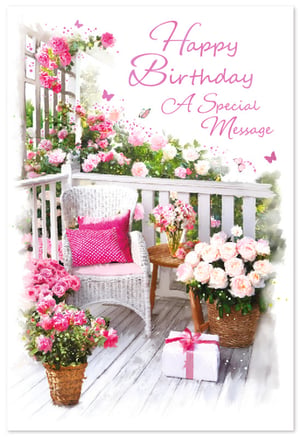 Delight your customers with this exquisite 'Open Birthday Female' card from Simon Elvin. This beautiful design captures the essence of a perfect celebration, featuring a charming porch scene overflowing with an abundance of delicate pink and white roses. A cosy white wicker chair, adorned with a vibrant pink cushion, invites relaxation, while a thoughtfully wrapped gift box adds to the festive atmosphere. Elegant pink butterflies flutter amongst the blooms, complementing the heartfelt 'Happy Birthday A Special Message' greeting. Perfect for any special woman, this card offers a truly lovely way to send warm wishes. Available in a convenient pack of 6.