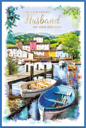 Celebrate a special birthday with this exquisite 'Husband' card, featuring a truly captivating watercolour scene. This charming design transports you to a picturesque harbour village, complete with colourful houses, lush green hills, and tranquil waters where two traditional rowing boats gently rest beside a rustic wooden jetty.

The serene beauty and artistic detail make this card a wonderful choice for customers looking to express their love and appreciation. Perfect for an amazing husband, this card offers a heartfelt message on a truly stunning backdrop.

Supplied by the renowned Simon Elvin, these high-quality cards come in a convenient pack size of 1x6, ensuring your shelves are always stocked with this popular design. A beautiful card for a beautiful sentiment.