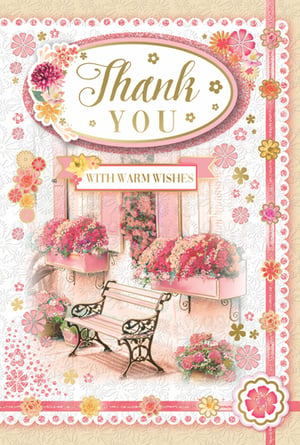 Express heartfelt gratitude beautifully with this charming "Thank You" card from Xpress Yourself. Featuring a delightful floral design, this card showcases a serene garden scene with a quaint bench and overflowing flower boxes in shades of pink and red. The elegant gold "Thank You" lettering is complemented by a "WITH WARM WISHES" banner, making it perfect for conveying sincere appreciation. Adorned with delicate glitter accents and intricate details, this card offers a truly special way to say thanks. Available in a convenient pack of 6, it's an ideal addition to any greeting card selection.