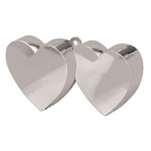 Two silver hearts are sitting next to each other on a white surface.
