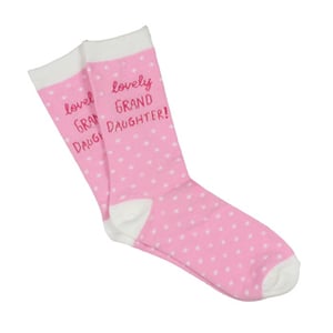 A pair of pink polka-dot socks that say "lovely granddaughter."