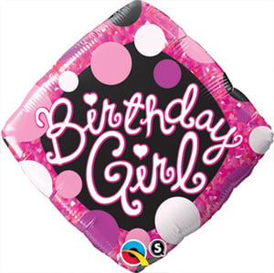 A balloon for the birthday girl with pink and purple polka dots.