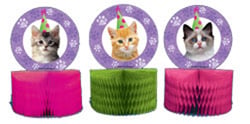 Three cats wearing party hats are on a pink and green item.