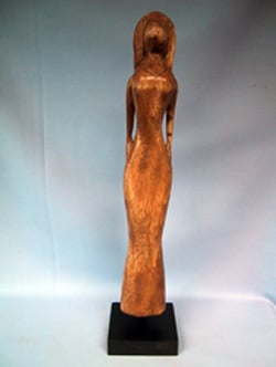 A statue of a woman in a long, brown dress.