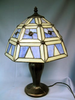 A lamp with a blue and white stained-glass shade.