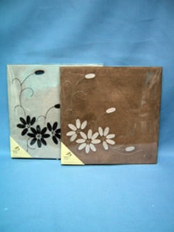 Two pieces of paper with flowers on them are on a blue background.