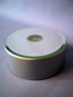 A silver container with a CD on top of it.