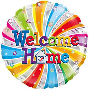 A colorful balloon with the words "Welcome home" written on it.