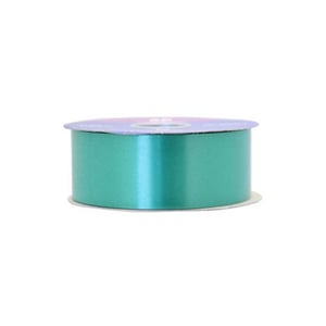 A roll of teal ribbon sits on a white surface.