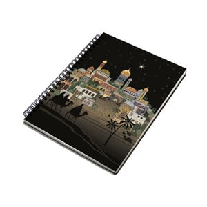 A spiral notebook with a nativity scene on it.