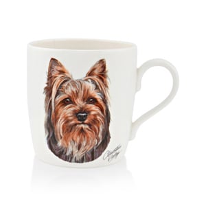 A white mug with a picture of a Yorkshire terrier is on it.