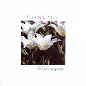 A thank-you card with a picture of white flowers.