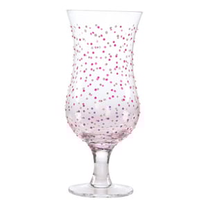 A clear glass with pink and white polka dots on it.