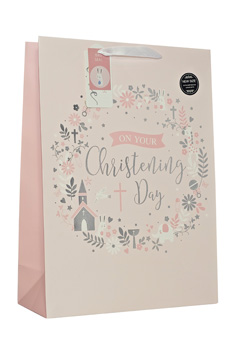 A pink gift bag that says "on your christening day."
