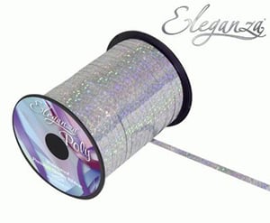 A close-up of a spool of silver ribbon on a white background.