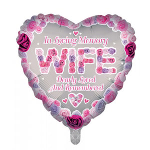 A heart-shaped balloon that says "in loving memory, wife dearly loved and remembered."