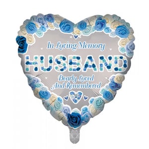 A heart-shaped balloon that says "In loving memory, husband dearly loved and remembered".