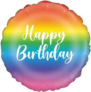 A rainbow foil balloon with the words "happy birthday" written on it.