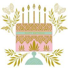 A pink and gold birthday cake with candles and leaves is on a white background.