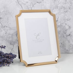 A picture frame that says "elegance" on it.
