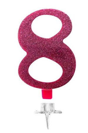 A pink birthday candle in the shape of the number eight is on a white background.