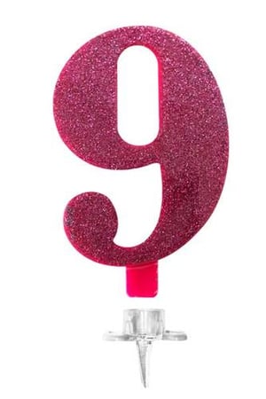 A pink glitter birthday candle in the shape of the number nine is on a white background.