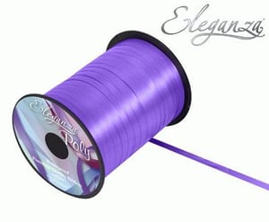 A spool of purple ribbon on a white background.