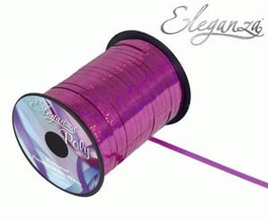 A spool of purple ribbon on a white background.
