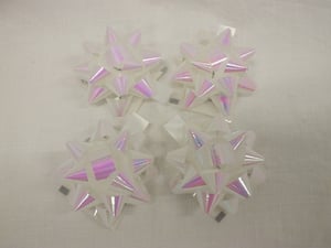 A set of three white bows with pink edges.