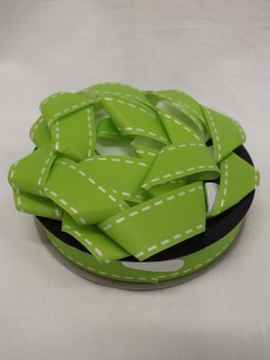 A green helmet with white stitching on it.